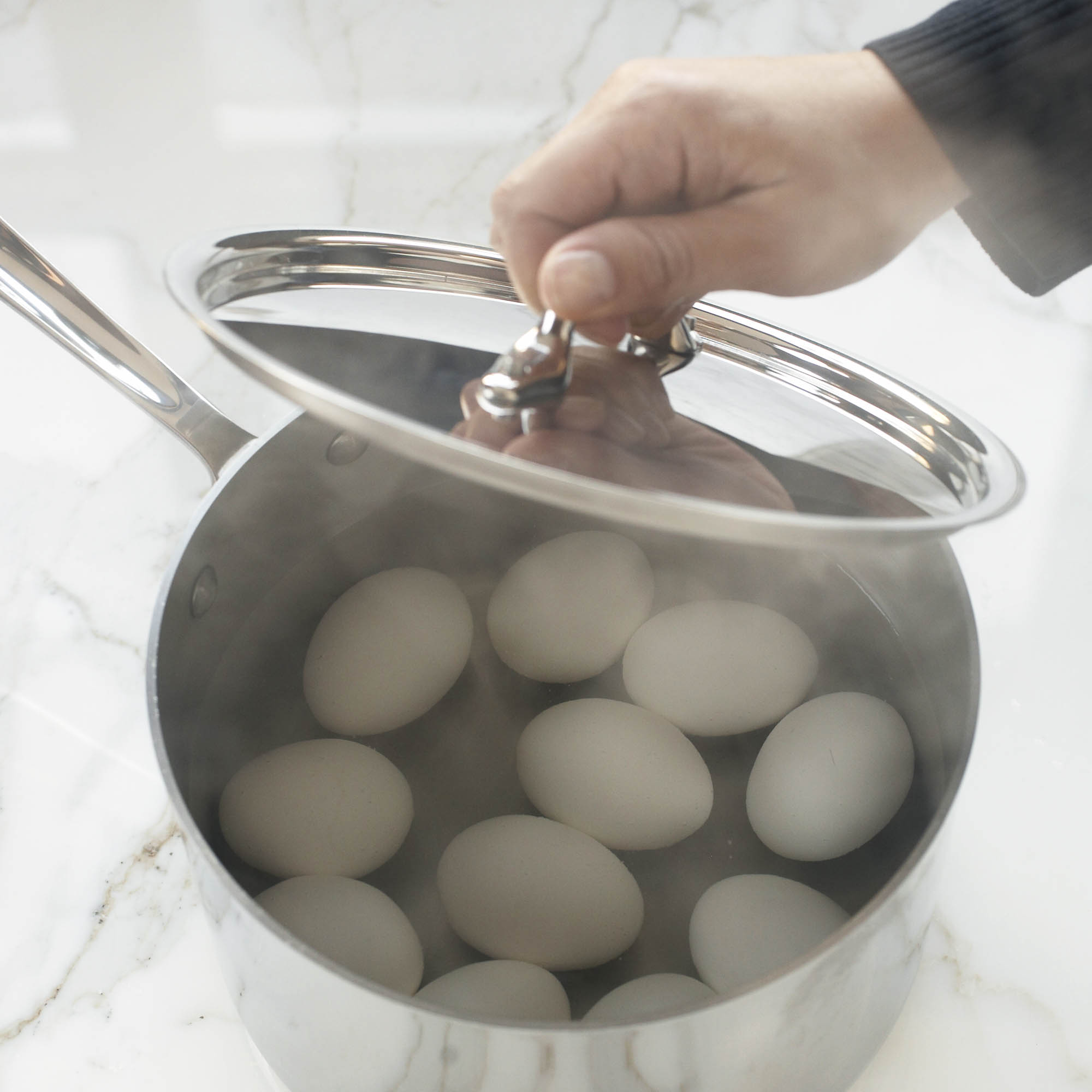 whole eggs in a pot of hot water