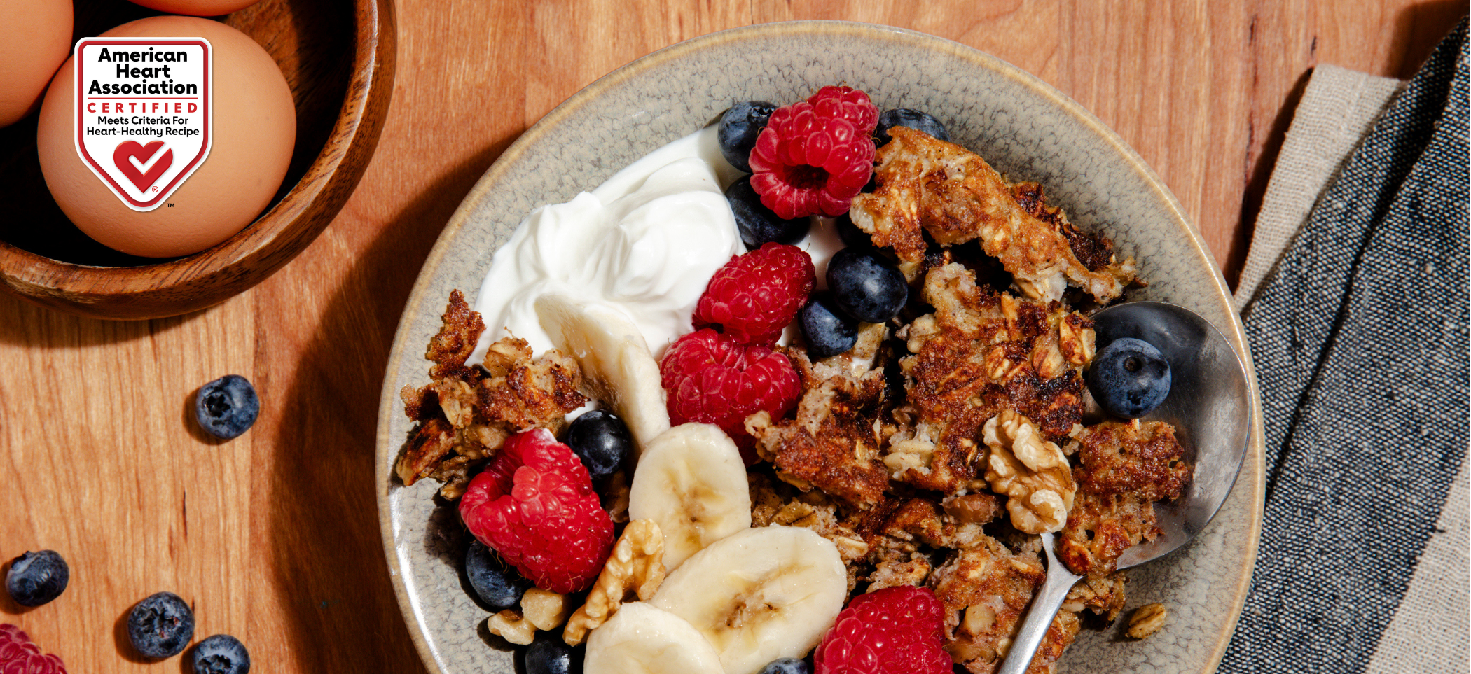 Scrambled oat dish topped with yogurt and fresh fruit